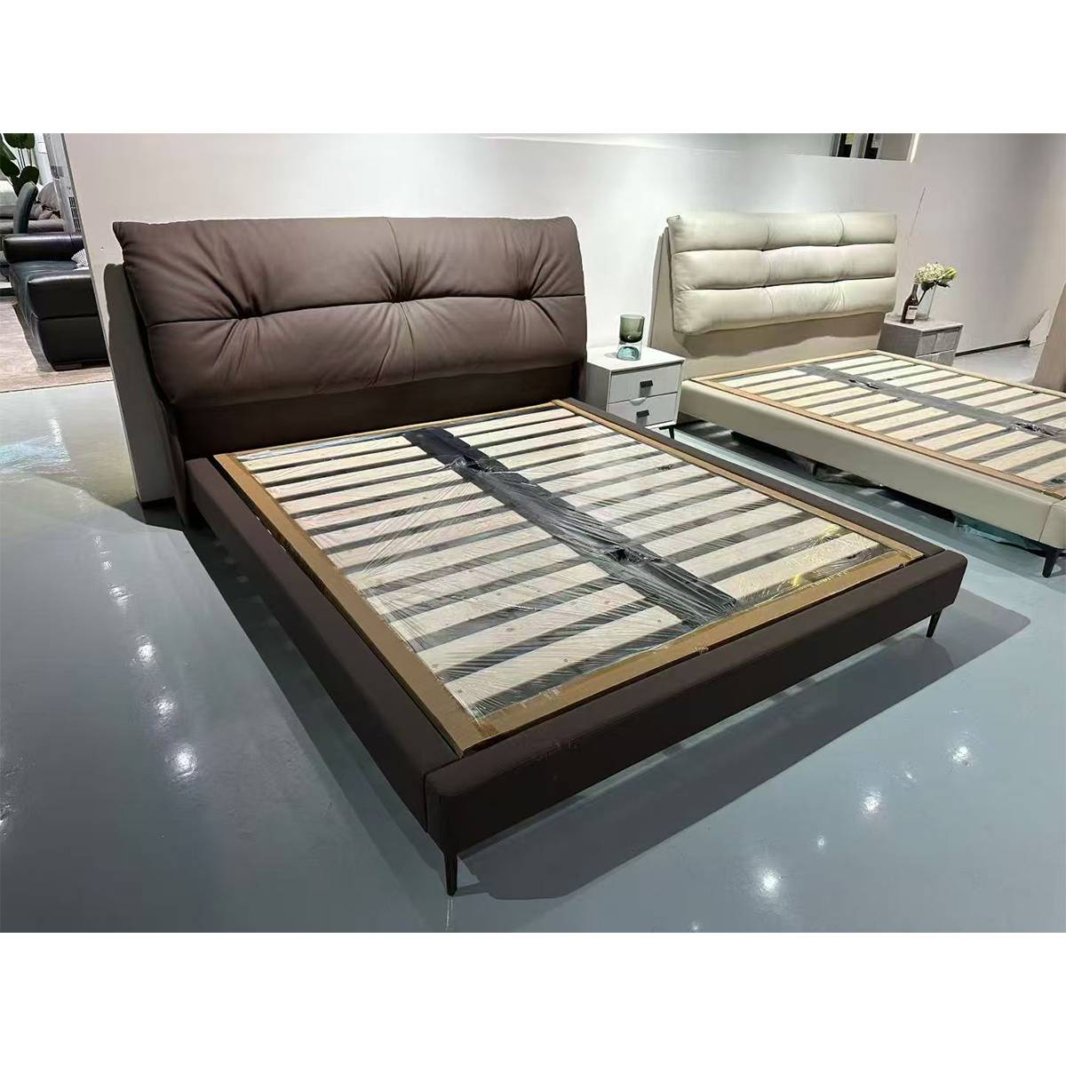 Wine red leather soft bed with wooden slat base in showroom