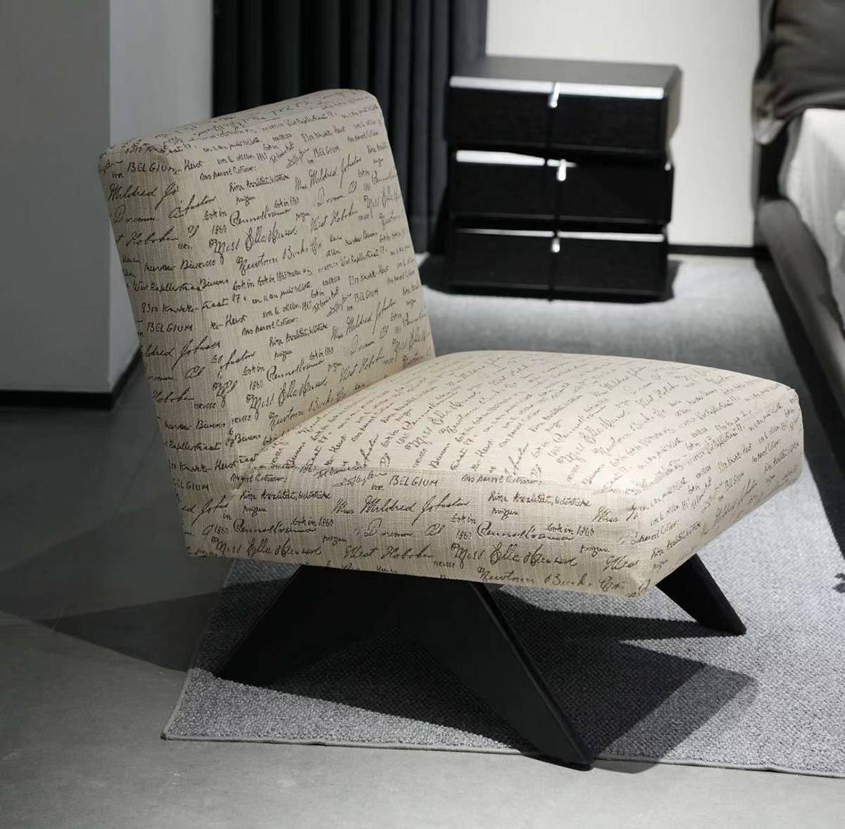 The Banji Single Sofa Chair placed in a bedroom setting next to a bed and nightstand