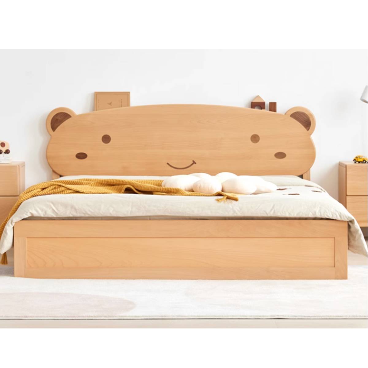 Front view of the wooden children's bed showing the bear face headboard and storage base.