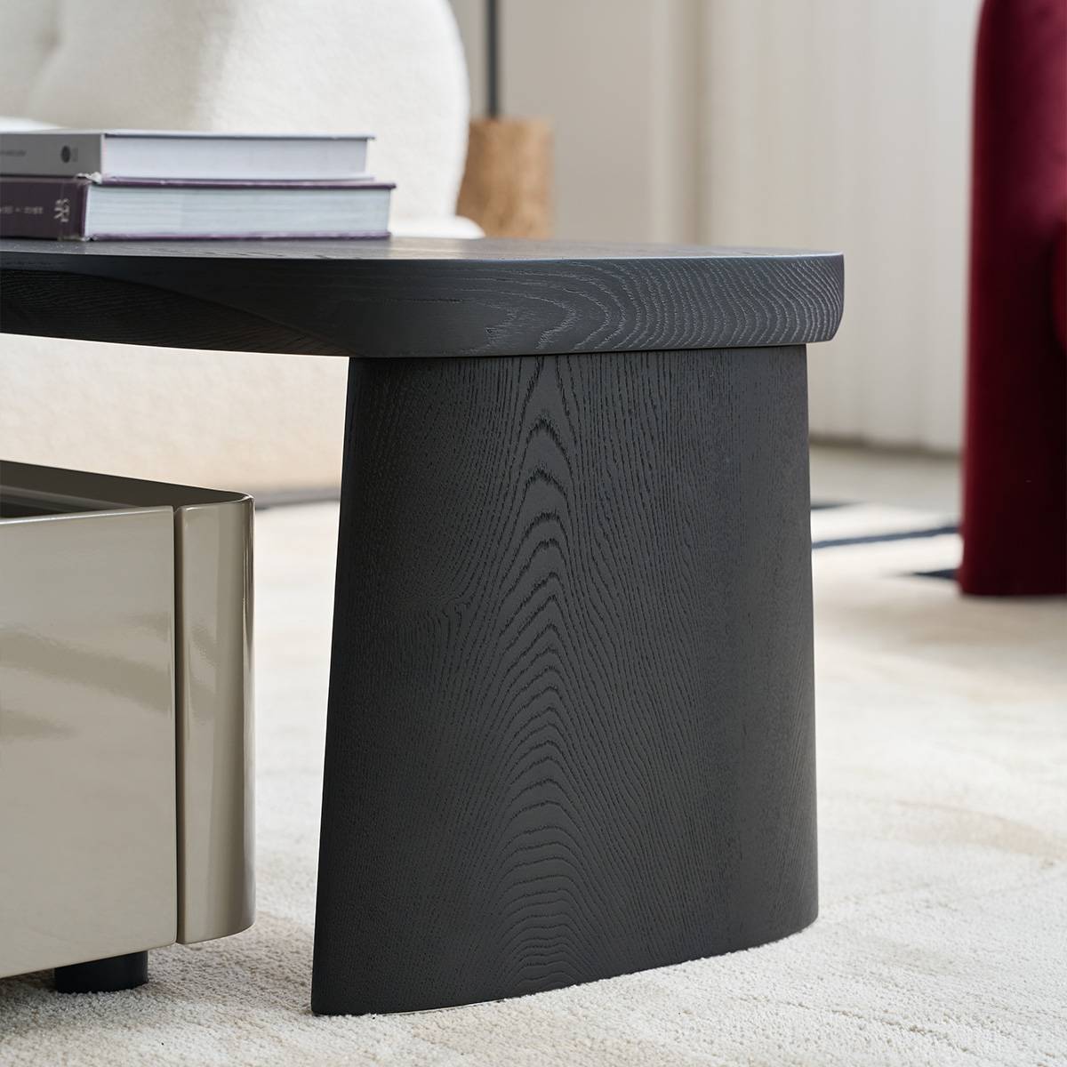 Close-up detail of the dark wood coffee table leg and surface texture.