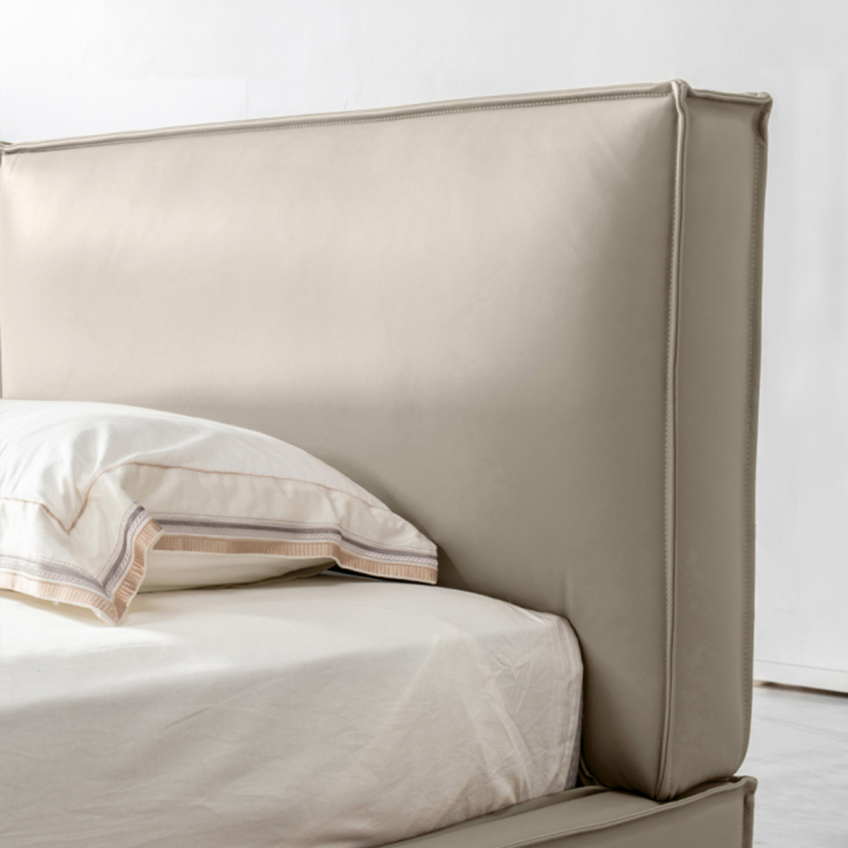 Side view of the leather bed in a modern bedroom setting