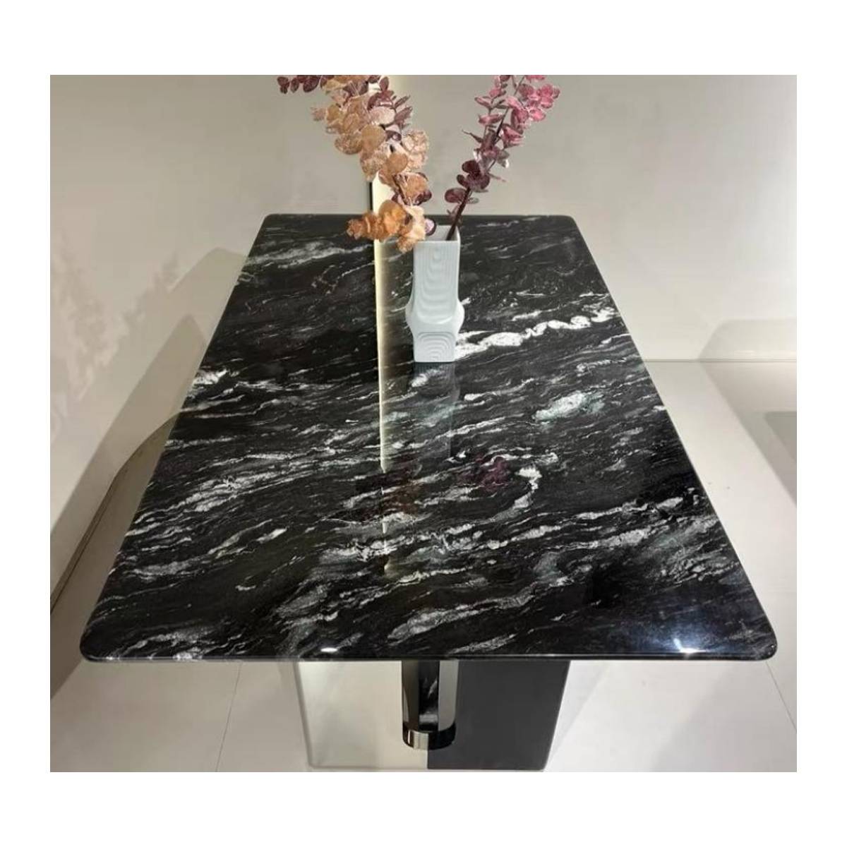 Close-up view of the Cosmic Black marble tabletop with floral arrangement