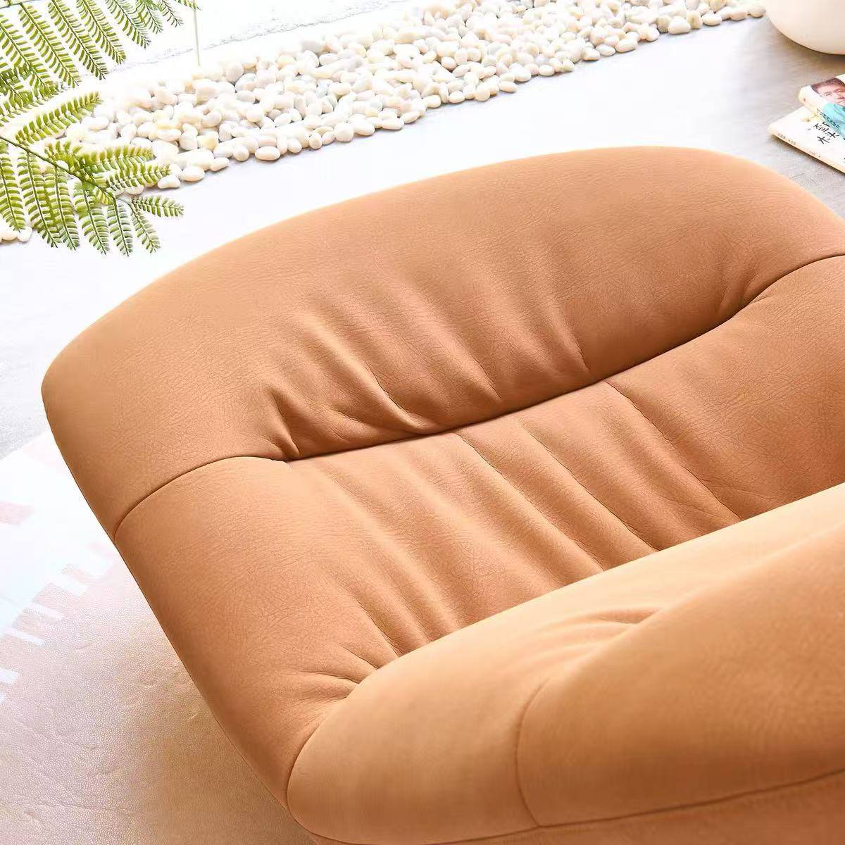Close-up view of the tan upholstery and cushioning of the rocking lounge chair