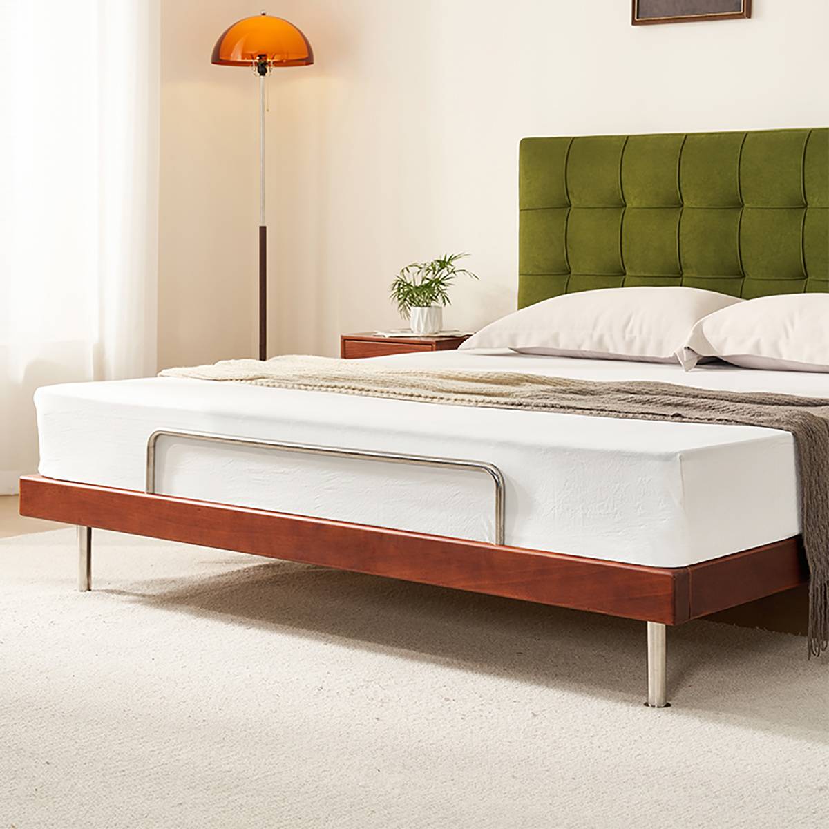 Side view of the mid-century bed with green velvet headboard and walnut frame
