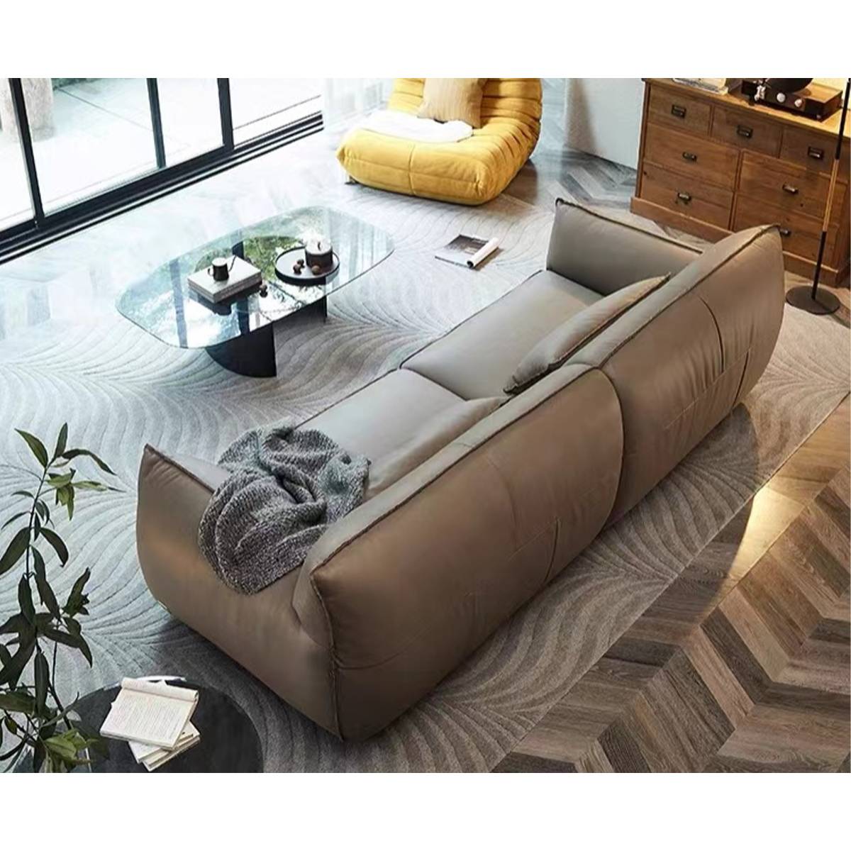 High-angle view of the sofa showing the full length and surrounding decor