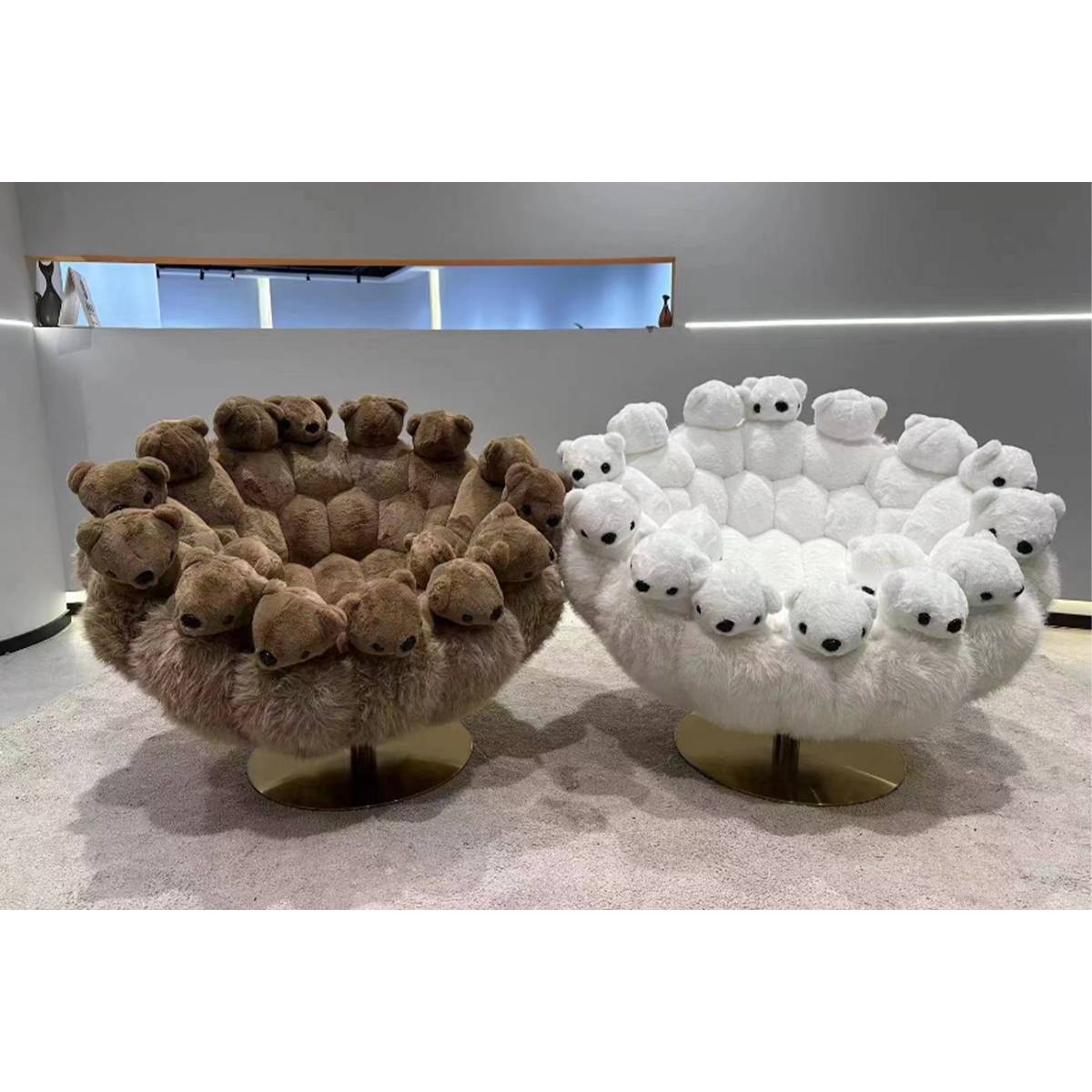 Two plush lounge chairs designed with teddy bear heads, one in brown and one in white, featuring stainless steel bases.