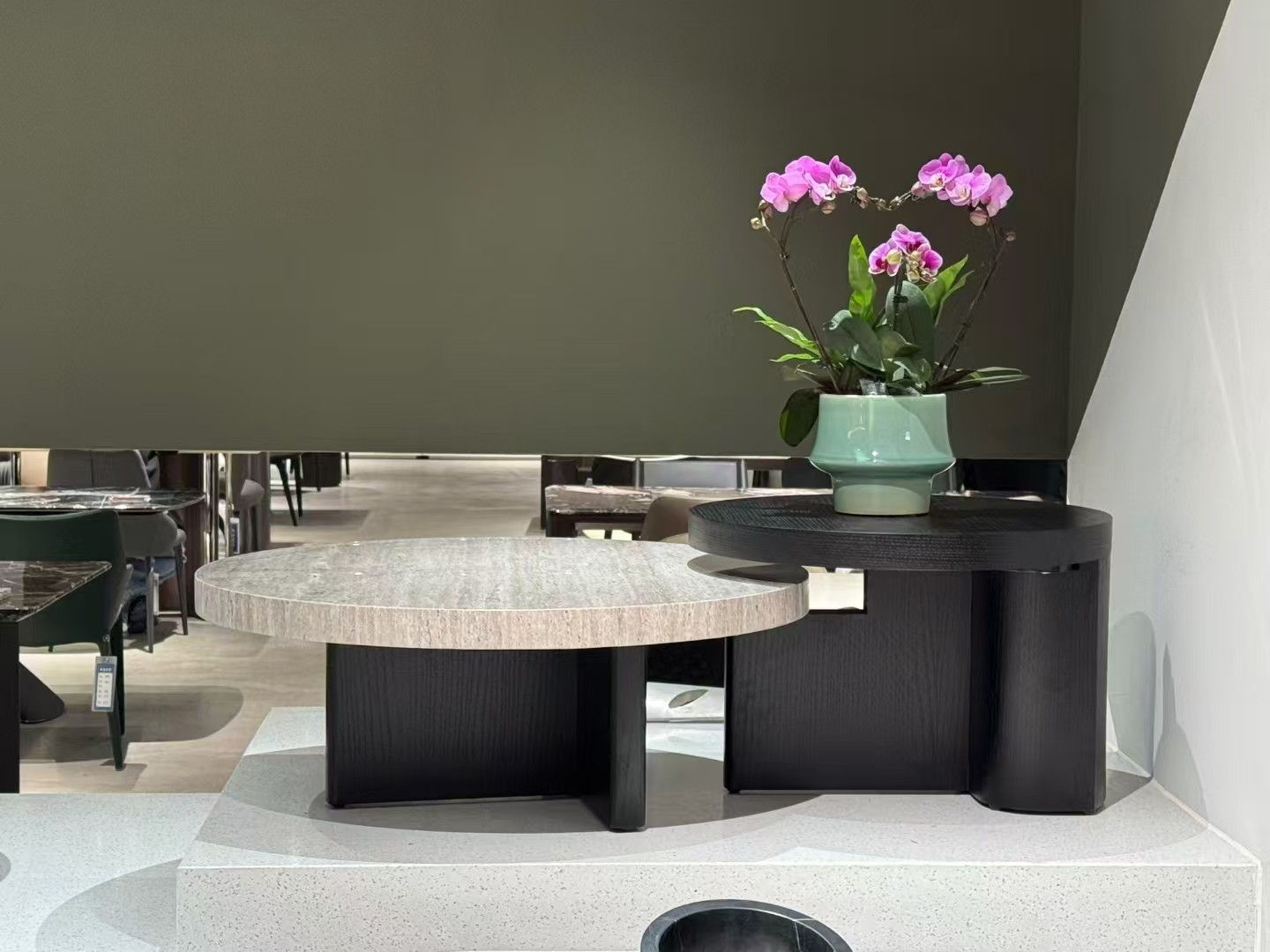 Full view of the dual coffee table set in a showroom setting, displaying the height difference and the stone-effect tops.