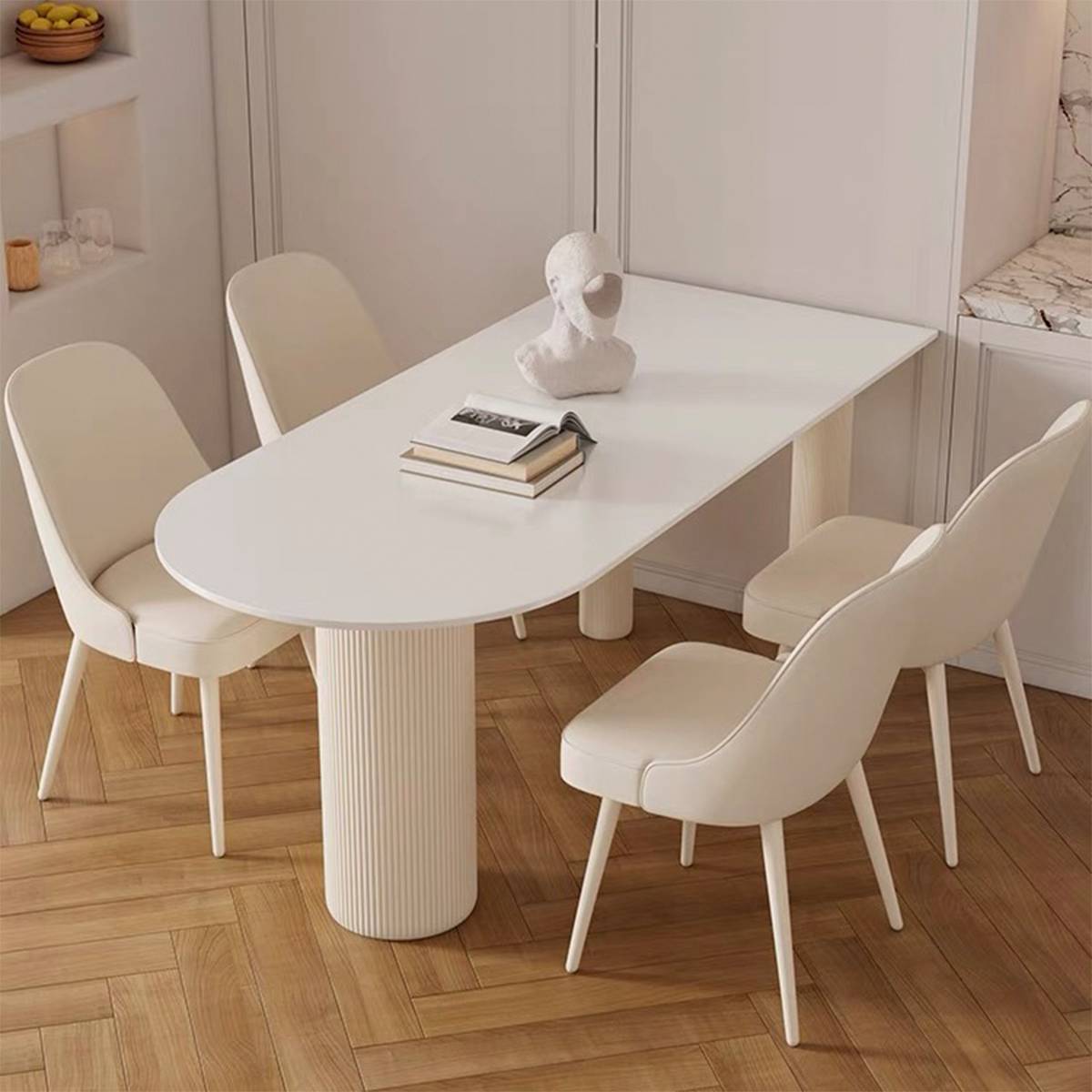 Dining table with chairs on a herringbone wood floor