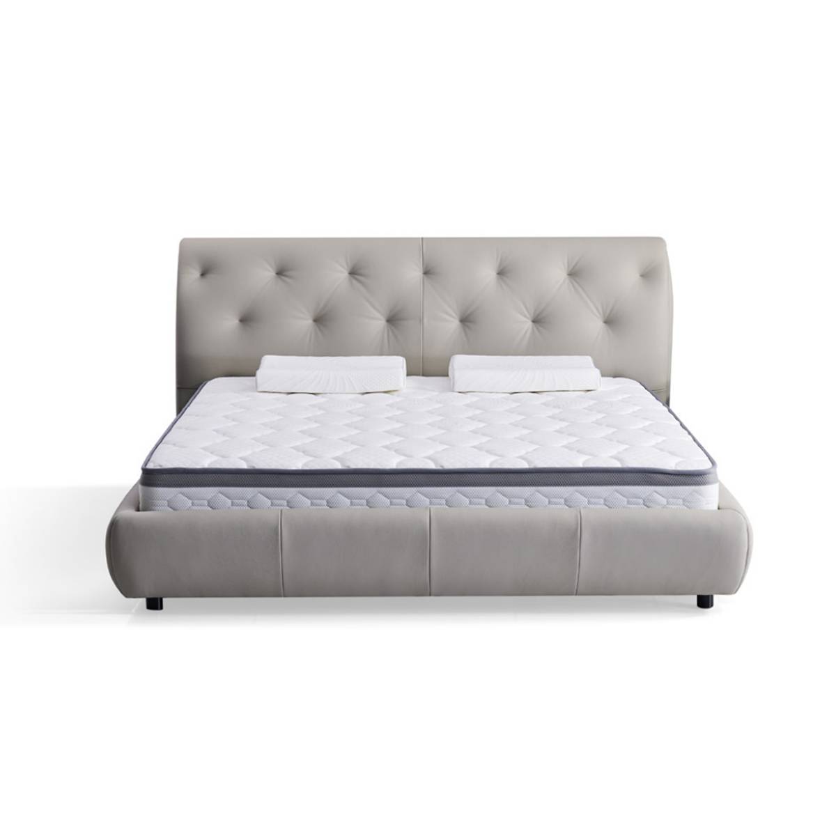 Front view of the grey tufted leather bed