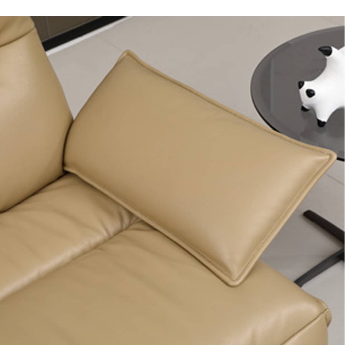 Close-up of the beige eco-leather recliner chair cushion and backrest