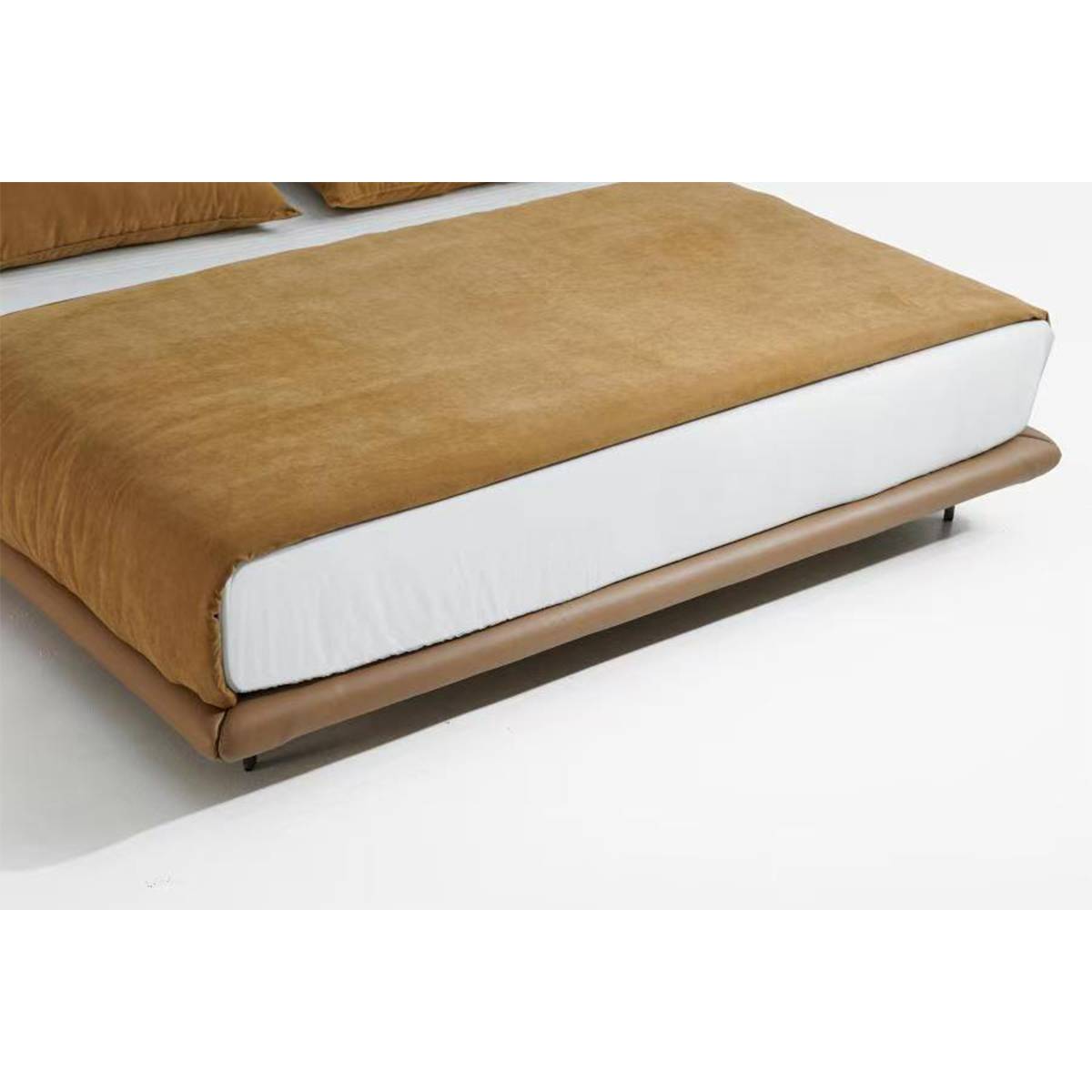 Close-up of the bed base showing the leather frame and floating legs