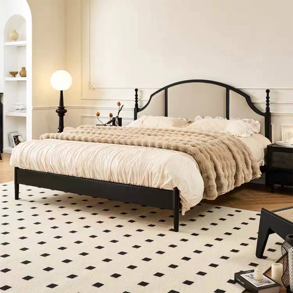 Front angled view of the bed showing the arched headboard and black frame details.