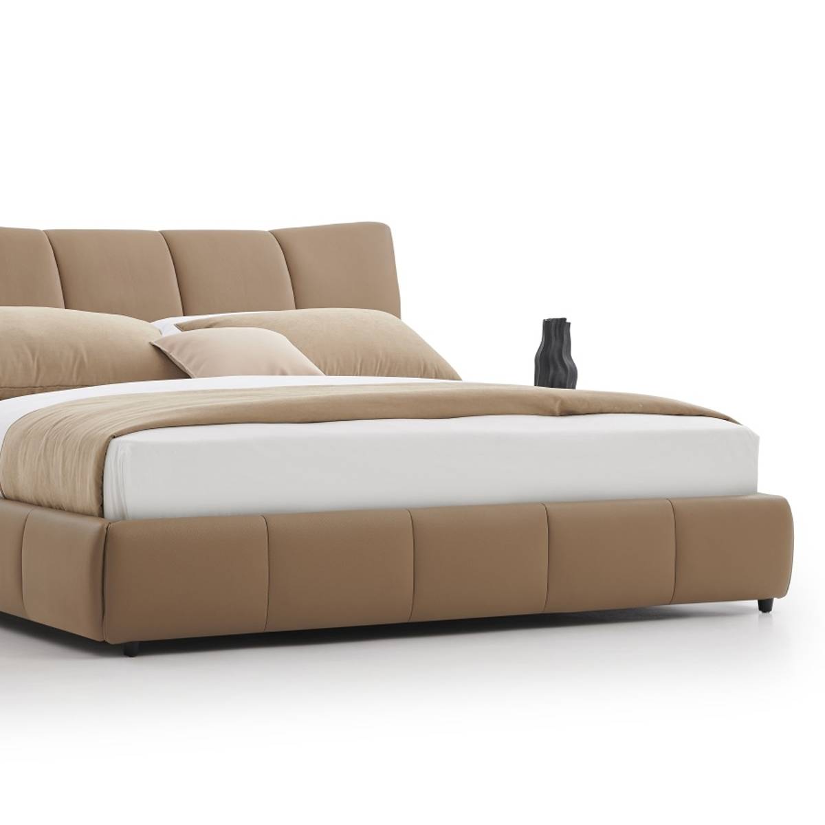 Hand pressing into the padded headboard to demonstrate softness and material quality