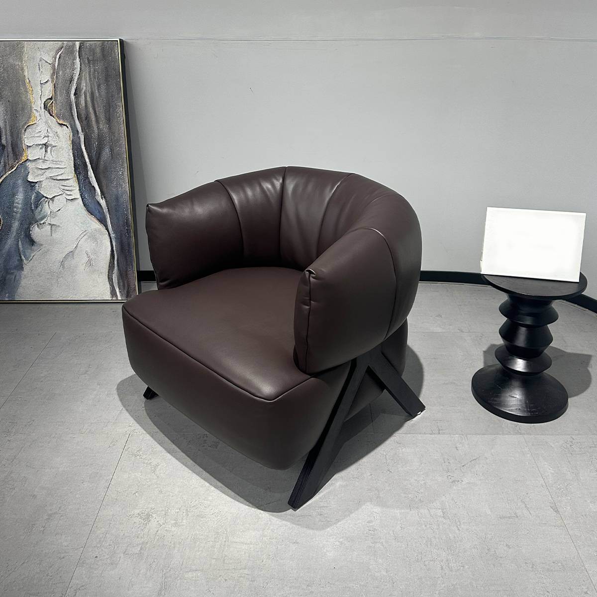 Front view of a brown leather lounge chair showing the seat and armrests
