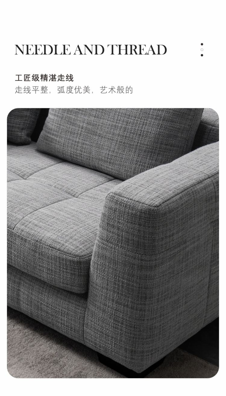 Close-up of the sofa armrest showing the texture of the grey fabric and precise stitching details.