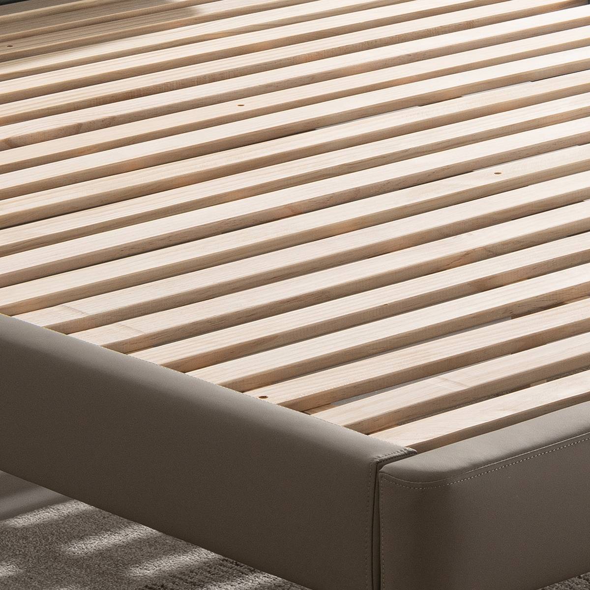 Detail shot of the wooden slat base and leather frame corner