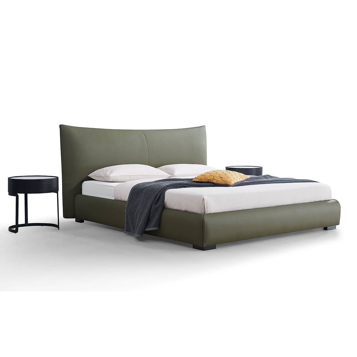Black leather soft bed in a modern bedroom setting with a floor lamp