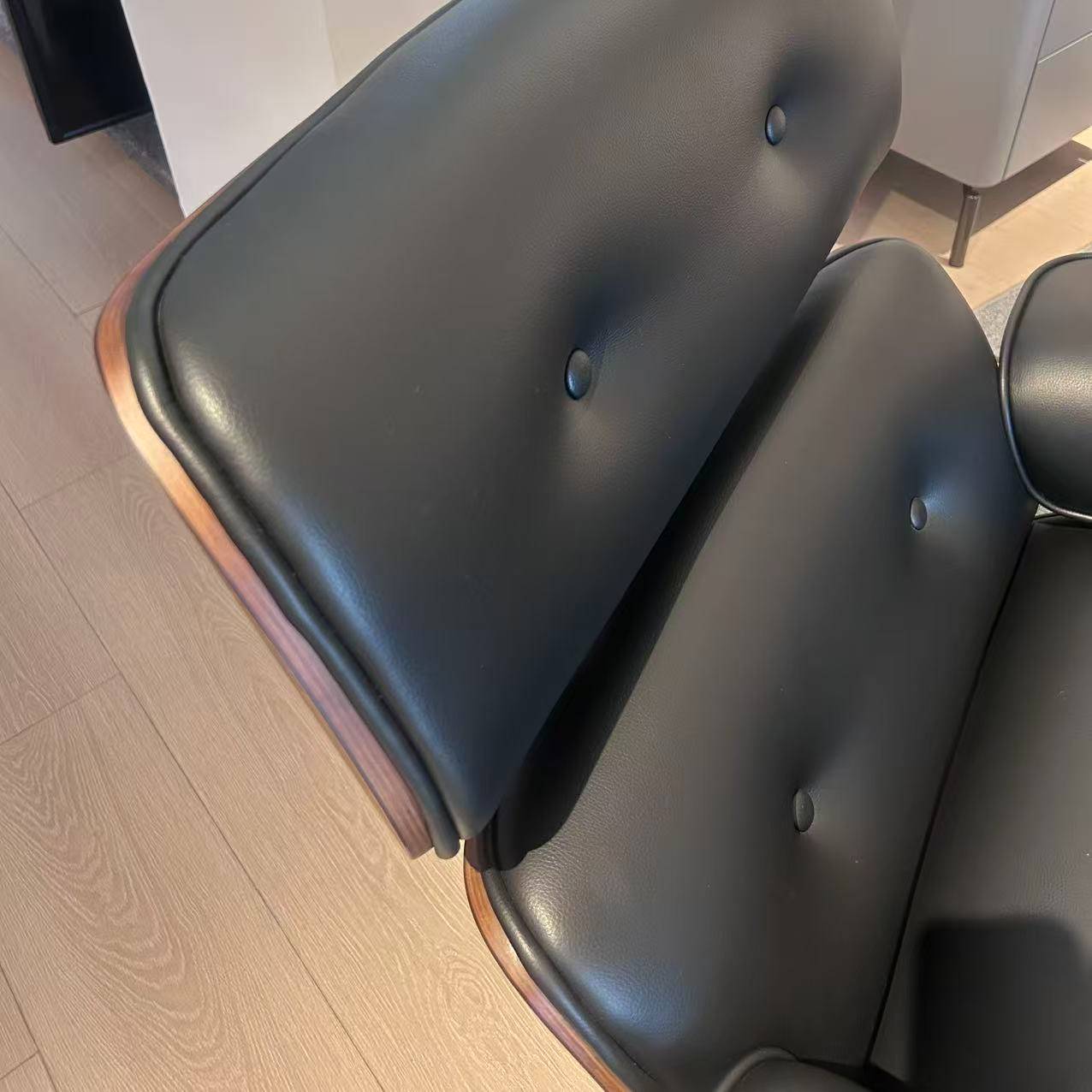 Close-up detail of the black eco-leather upholstery and button tufting