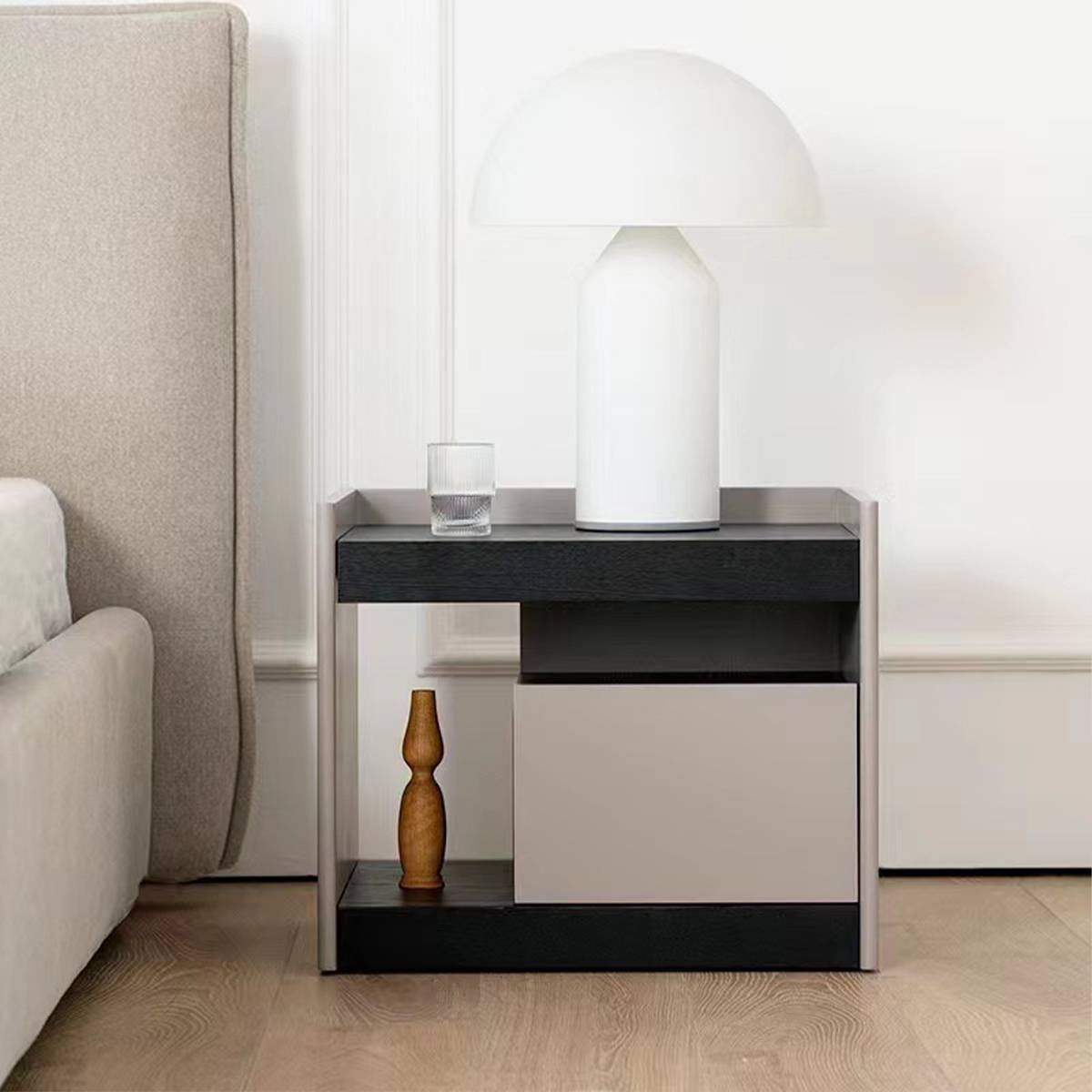 Front view of bedside table with lamp and glass