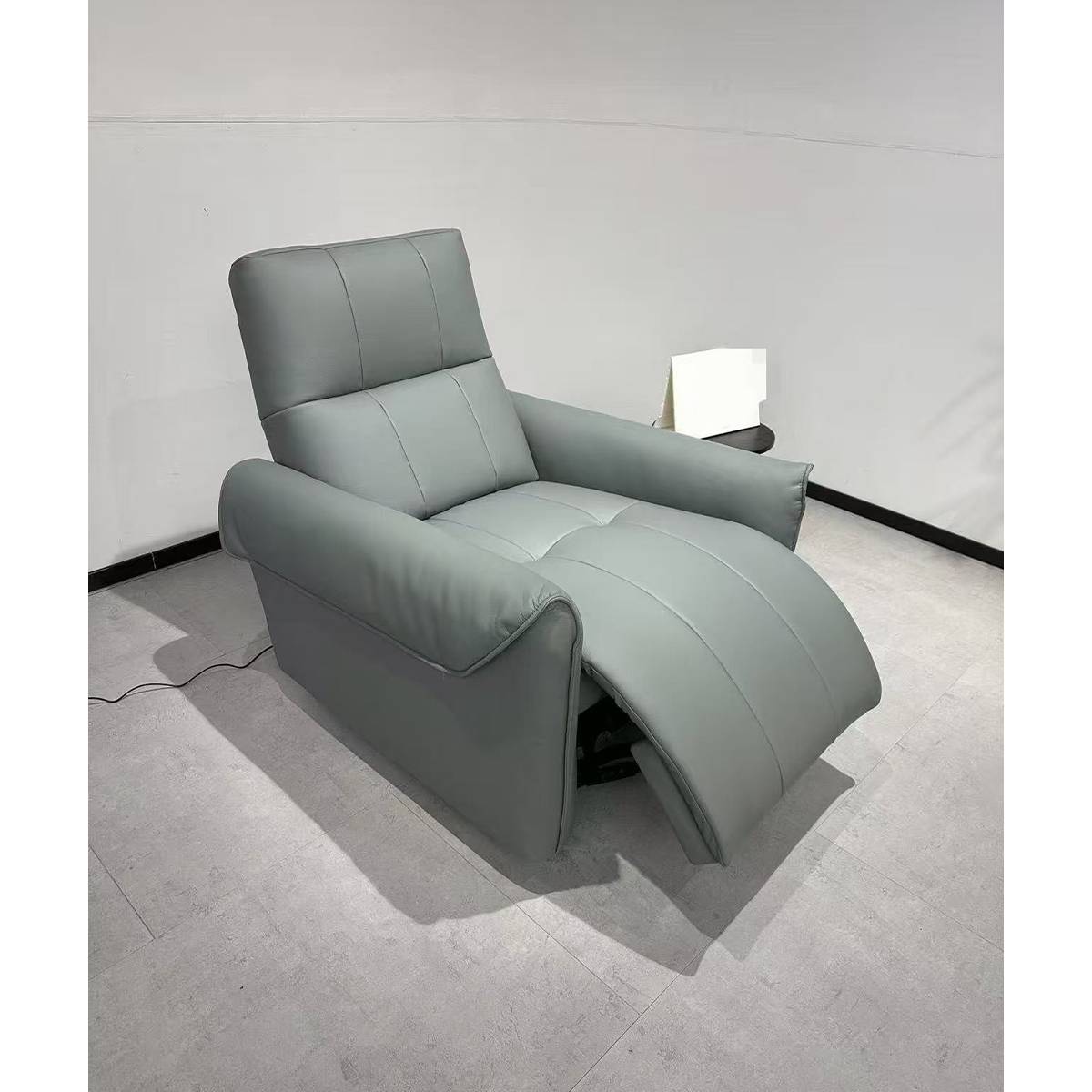 The electric recliner chair shown in a fully reclined position