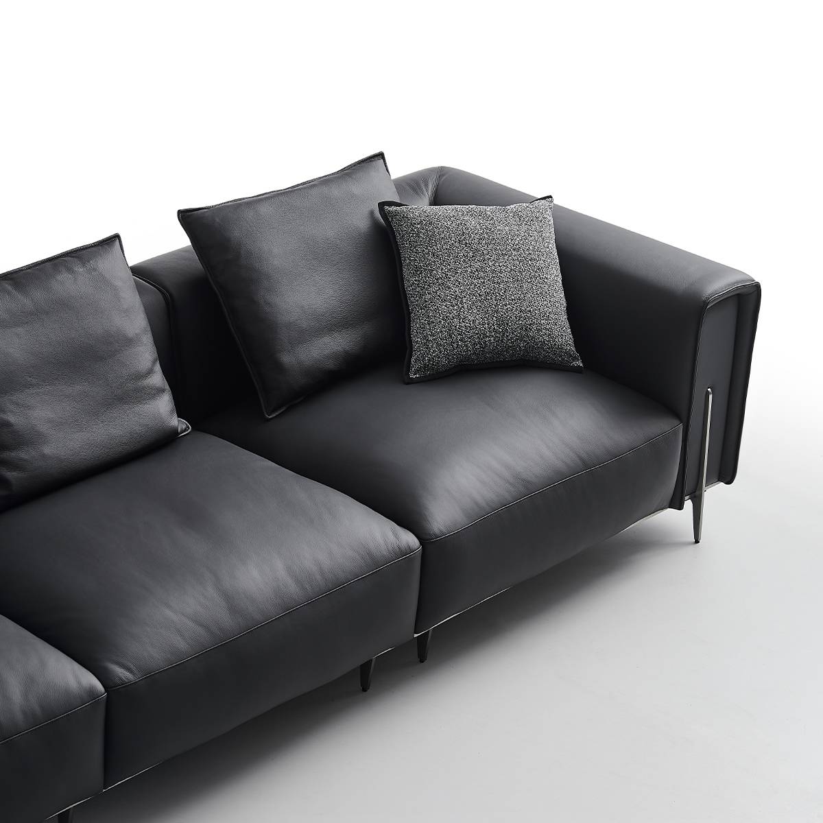 Close-up detail of the sofa seat cushion and metal leg