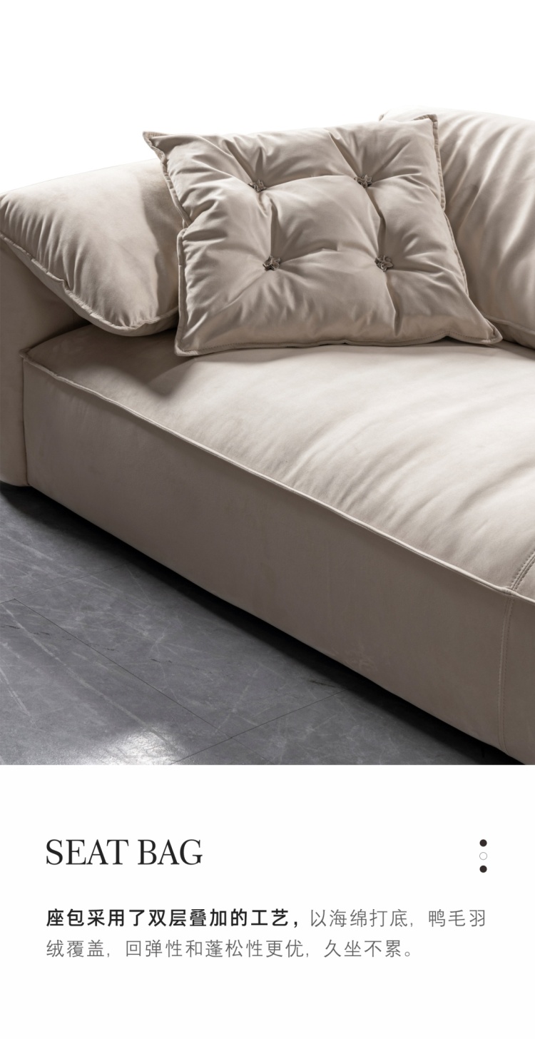 Close-up of the sofa seat cushion and tufted pillow, highlighting the fabric texture.