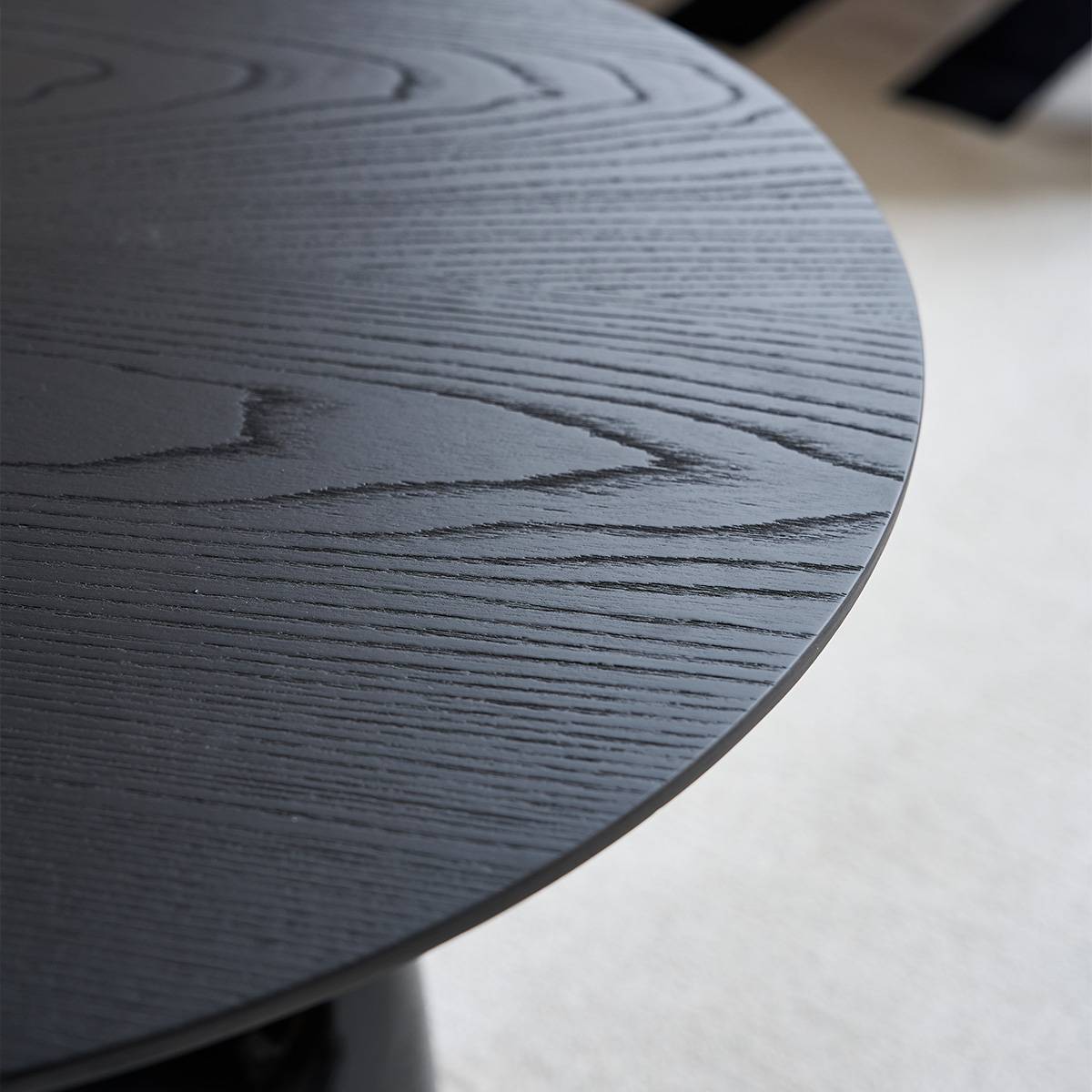 Close-up of the black wood veneer tabletop surface showing grain texture