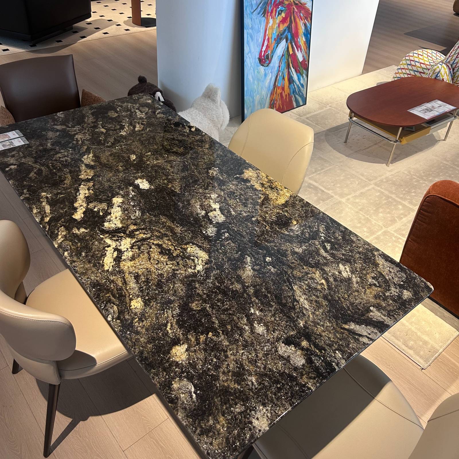 Top-down view of the Dazzling Galaxy natural stone dining table showing the intricate stone pattern and surrounding dining chairs.