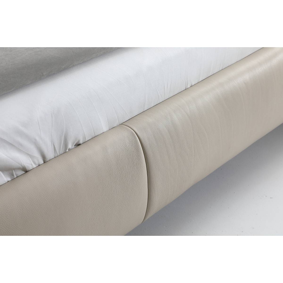 Close-up detail of the leather upholstery and stitching on the bed frame