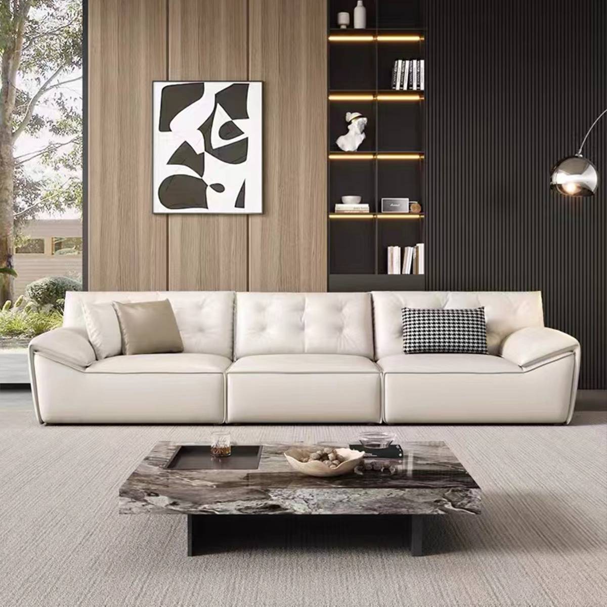 Front view of the white leather sofa with a marble coffee table