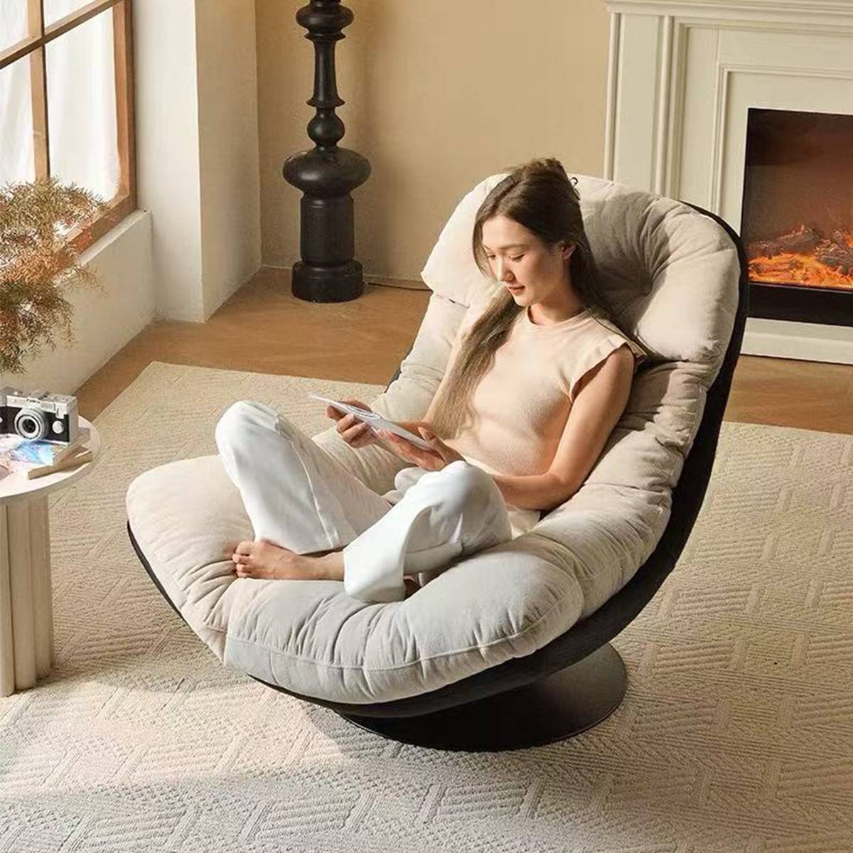 Woman reading in the white swivel lounge chair