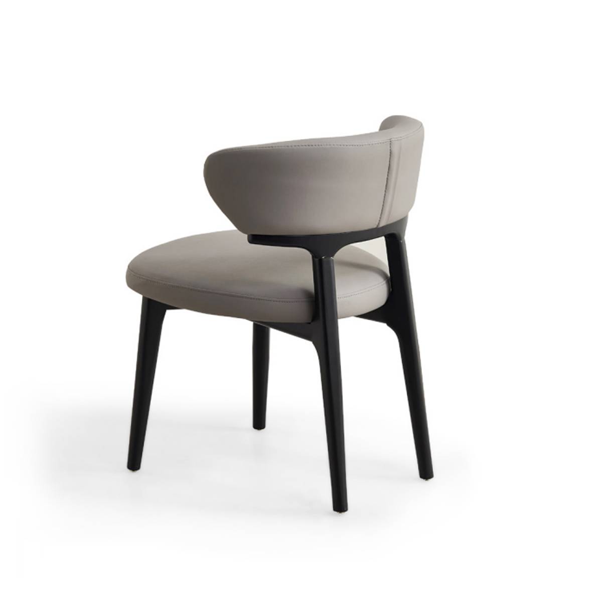 Side view of light grey upholstered dining chair showing curved backrest