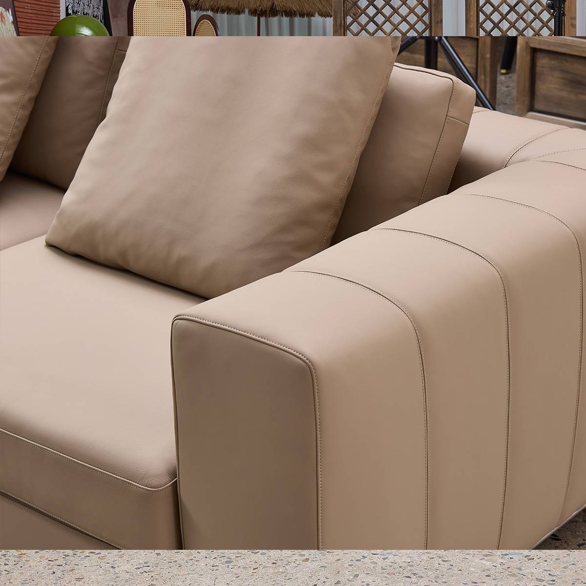 Close-up detail of the sofa armrest and leather texture