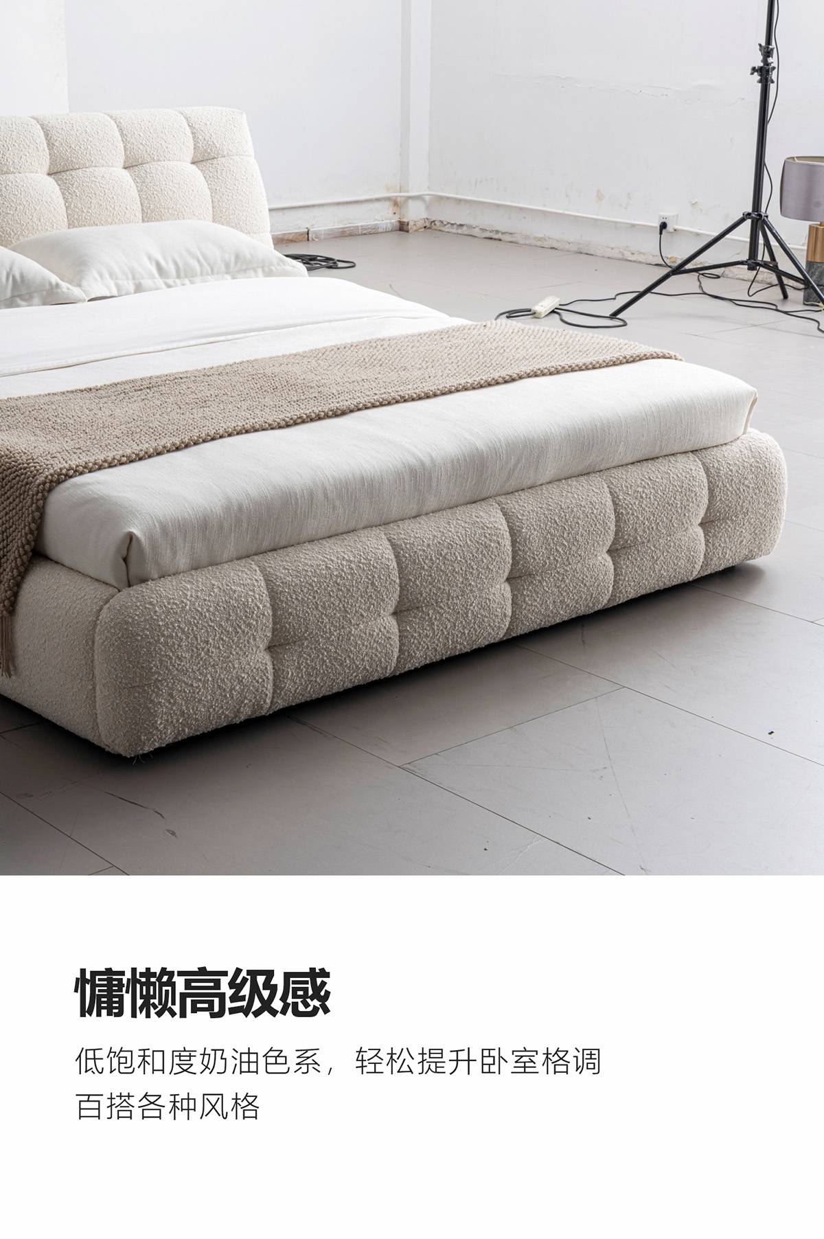 Close-up view of the bed showing the tufted fabric texture and bedding arrangement