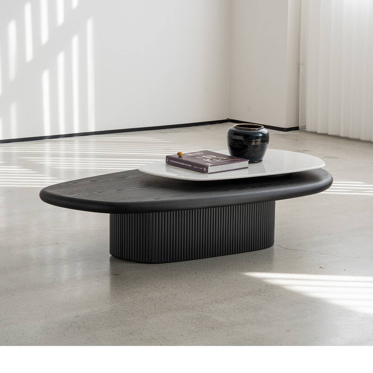 Side view of the coffee table showing the fluted base and room setting