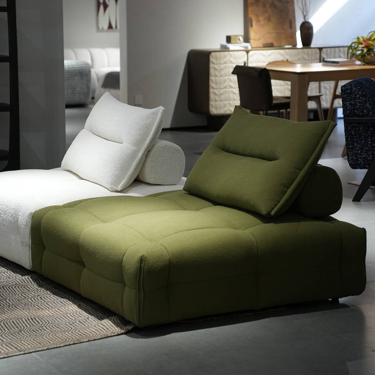 Green lounge chair paired with white version in living room setting