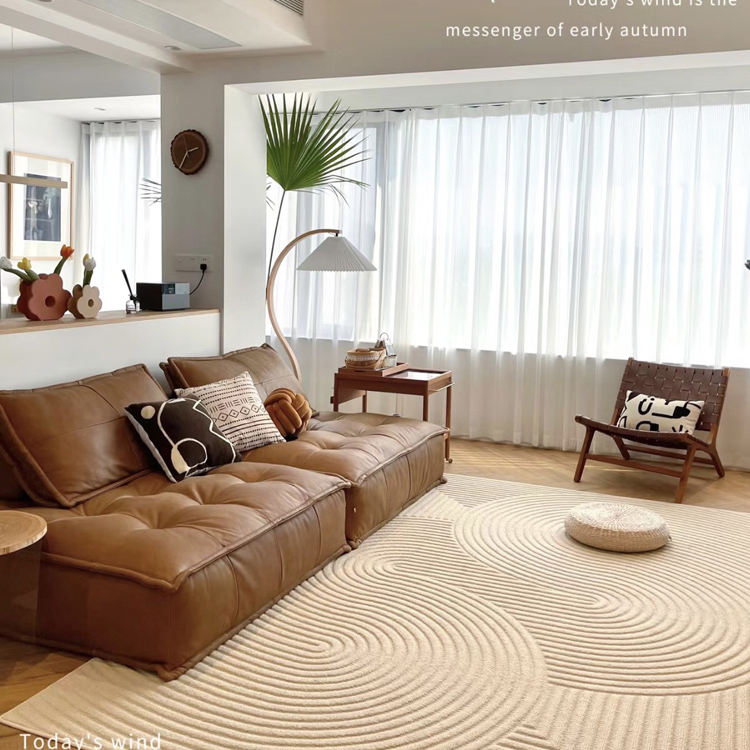 Close-up of the brown modular sofa showing the tufted seat cushions and pillows