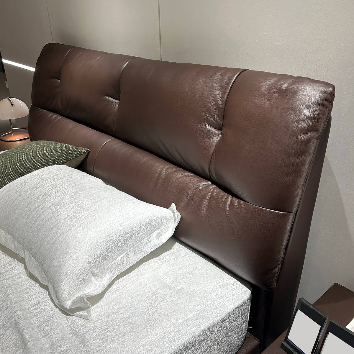 Close-up view of the brown leather tufted headboard of the B22 soft bed
