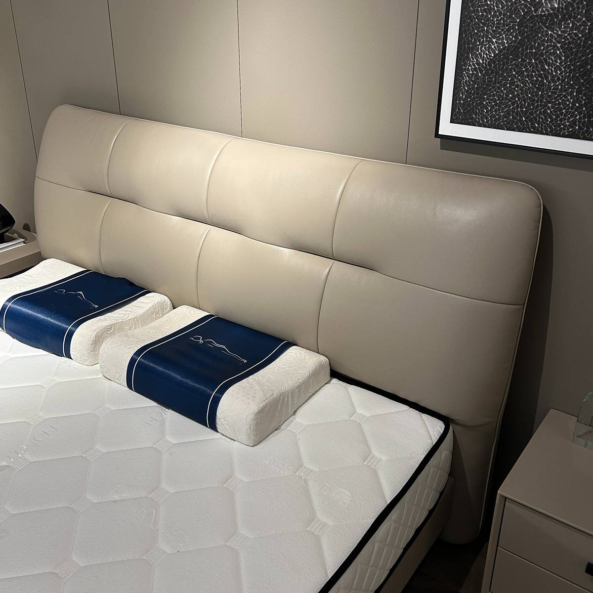 Close-up detail of the tufted leather headboard and mattress surface