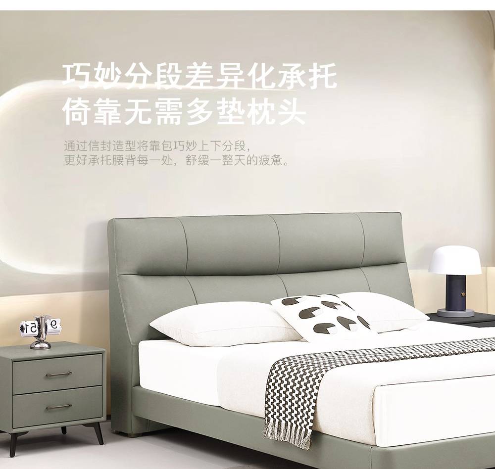 Full view of the grey leather bed with white bedding and a patterned throw