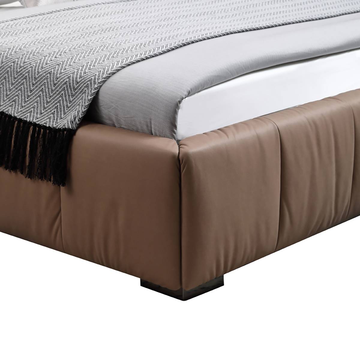 Close-up detail of the tufted leather base and leg