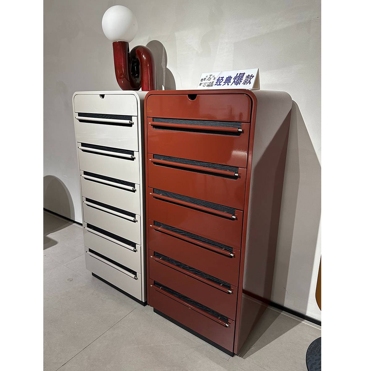 Angled view of the white and red 7-drawer cabinets