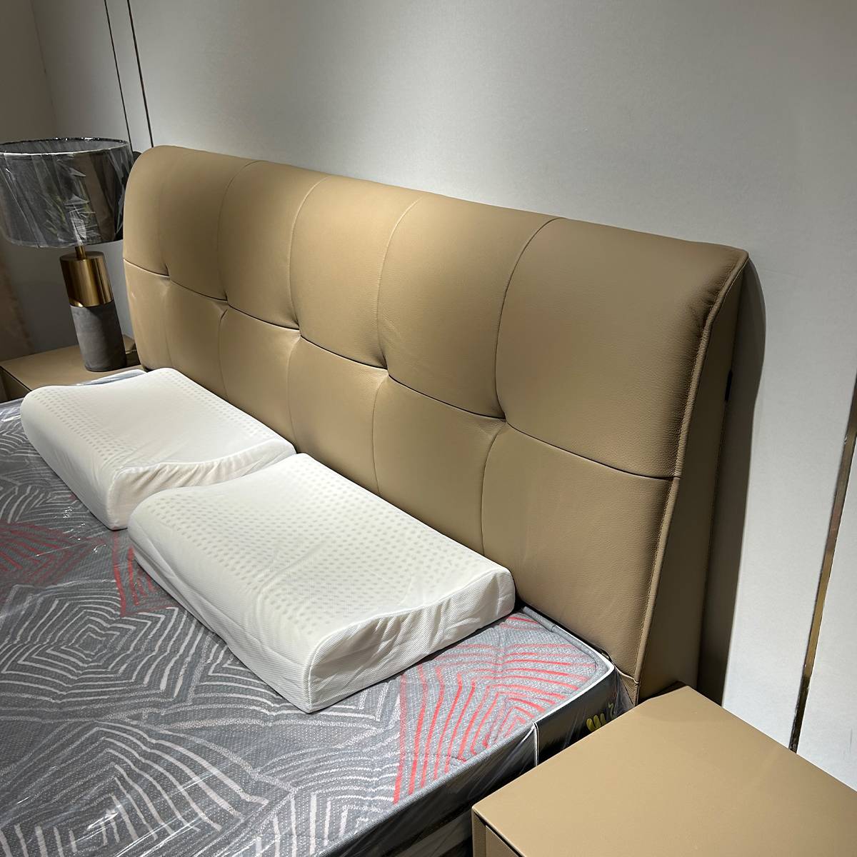 Close-up detail of the tufted leather headboard and mattress