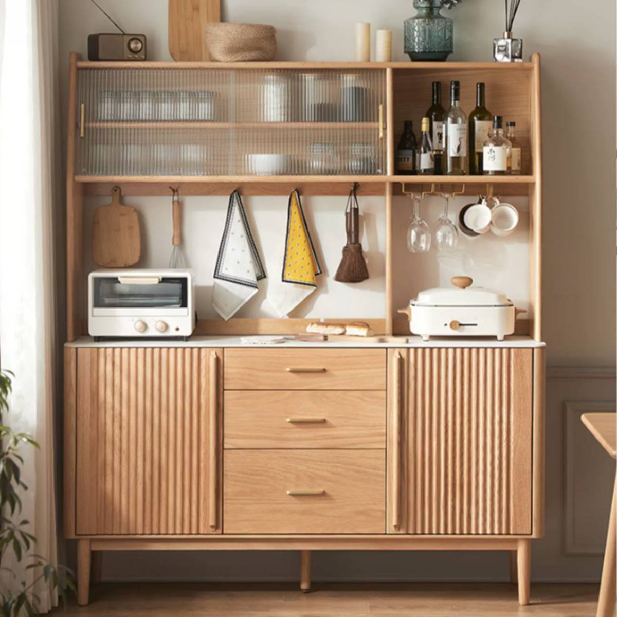 Light wood sideboard with upper hutch displaying kitchen items