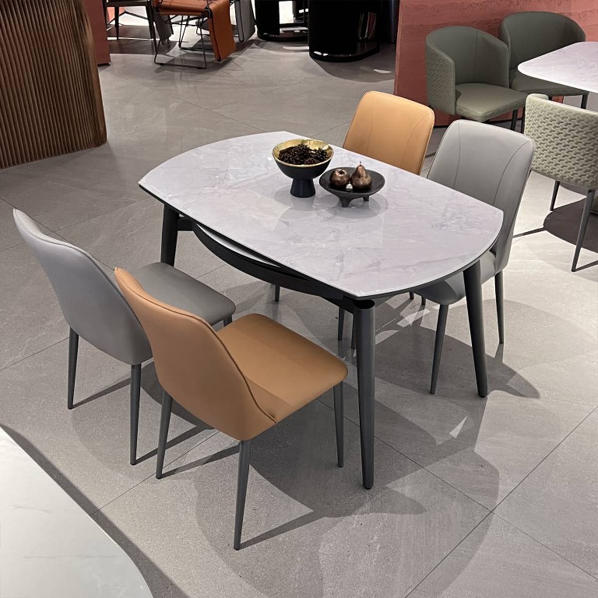 Dining table in extended rectangular mode with mixed grey and tan chairs