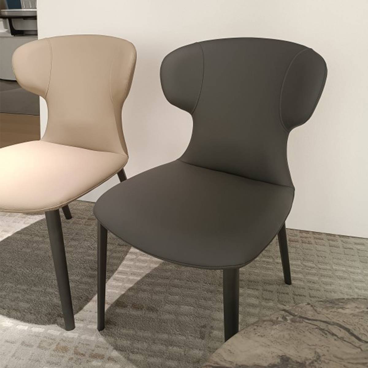 Close-up view of the dining chairs showing the upholstery texture and leg design