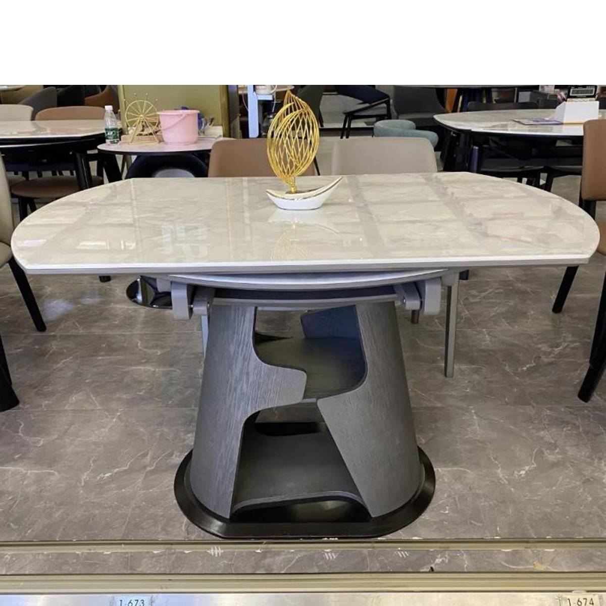 Close-up of the dining table showing the microcrystalline stone surface and base mechanism