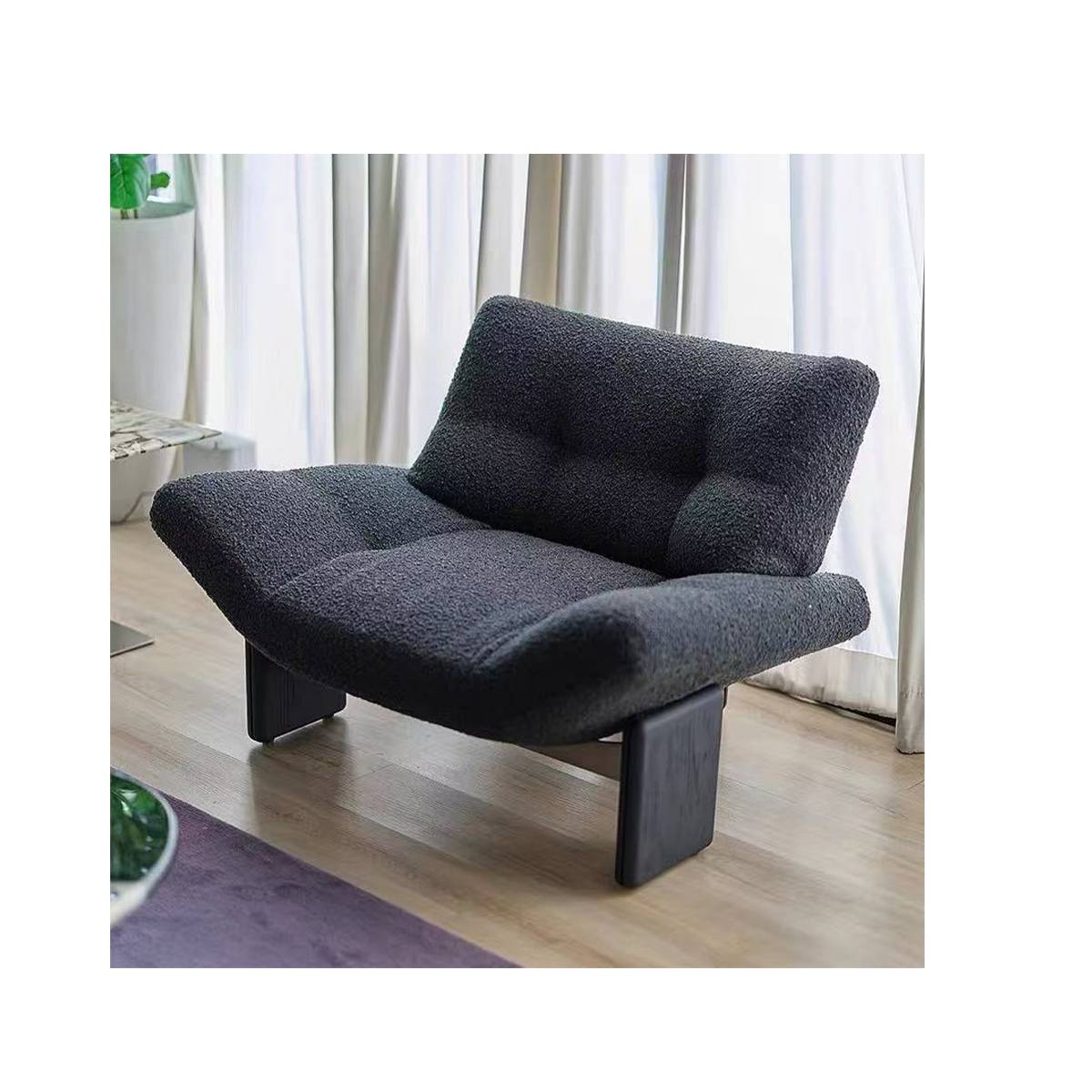 Dark grey lounge chair in a living room setting