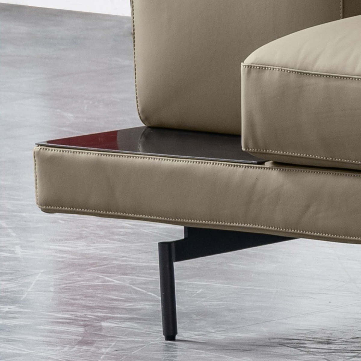 Full view of the beige leather corner sofa in a modern living room setting with a coffee table.