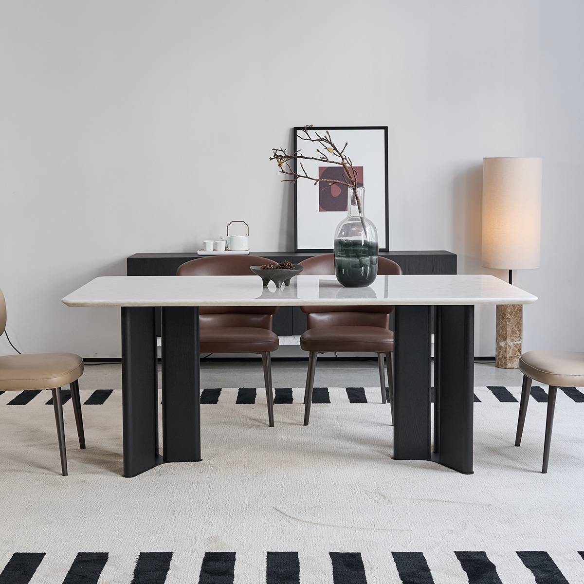 Front view of the dining table highlighting the natural stone texture and vase centerpiece